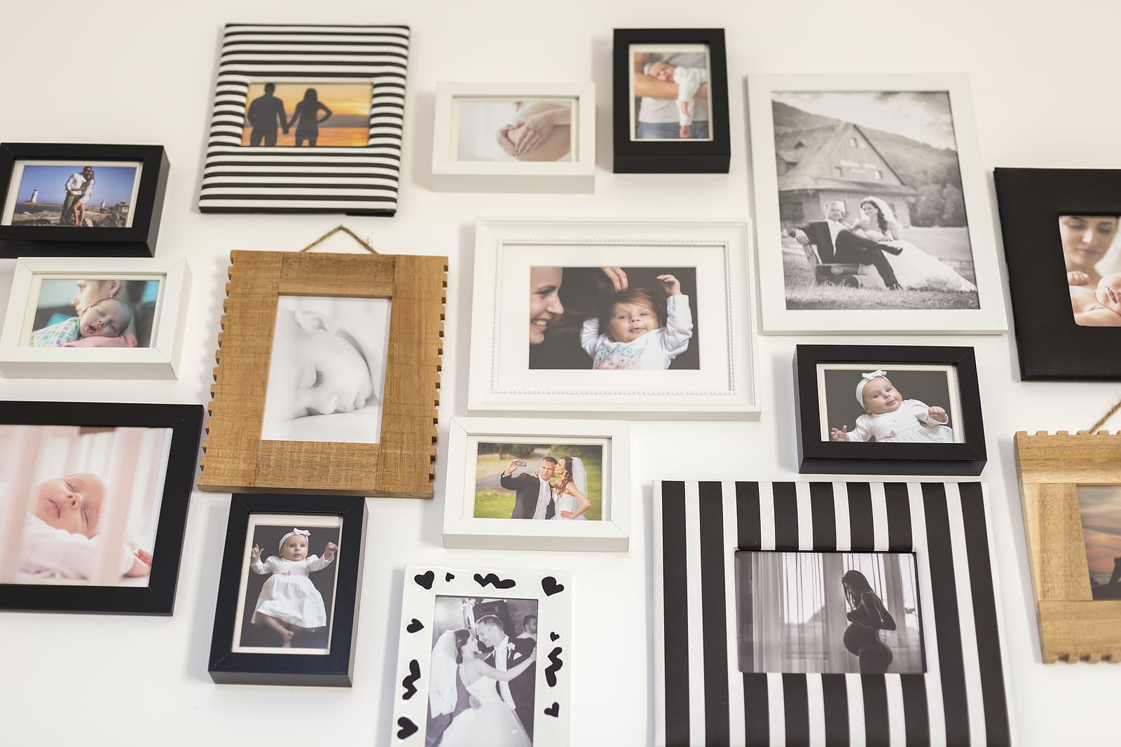 framers in Hackney - White-Wall-With-Photos-Of-The-Family-In-Various-Photo-Frames